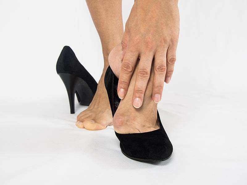 Taking of black high heels