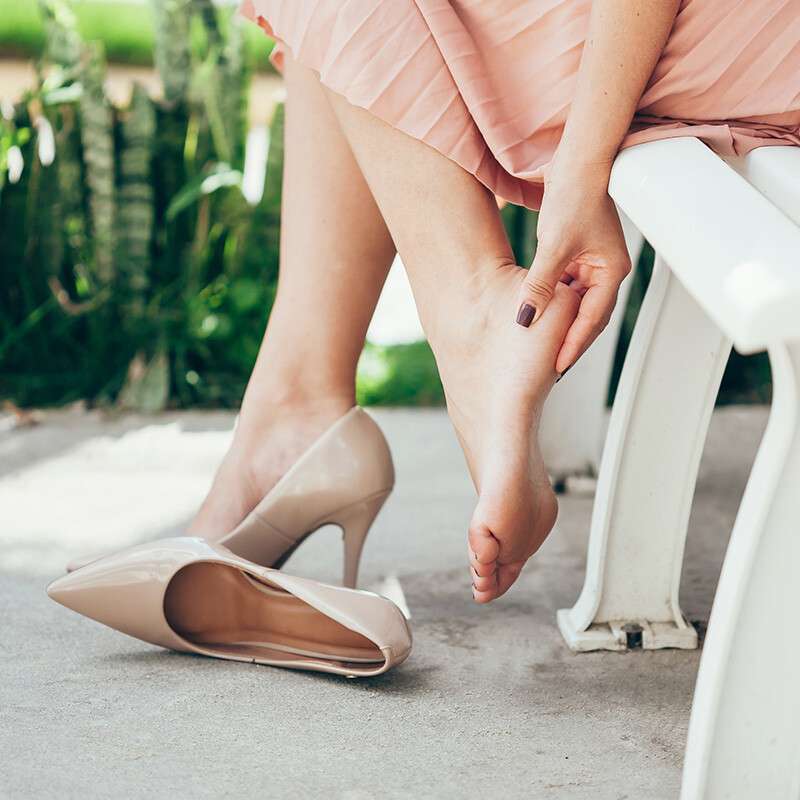 Feet in beige heels