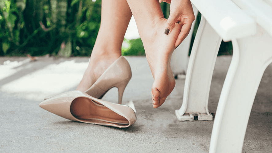 Feet in beige heels